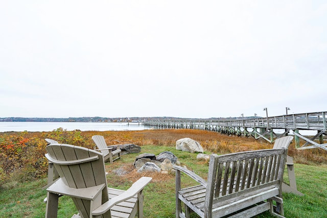 view of yard featuring a fire pit and a water view