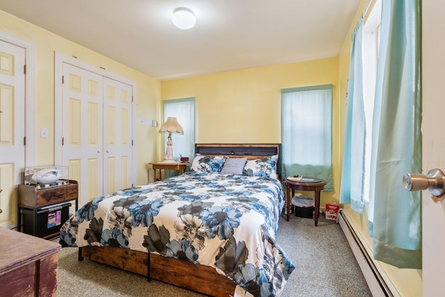 carpeted bedroom featuring a baseboard heating unit