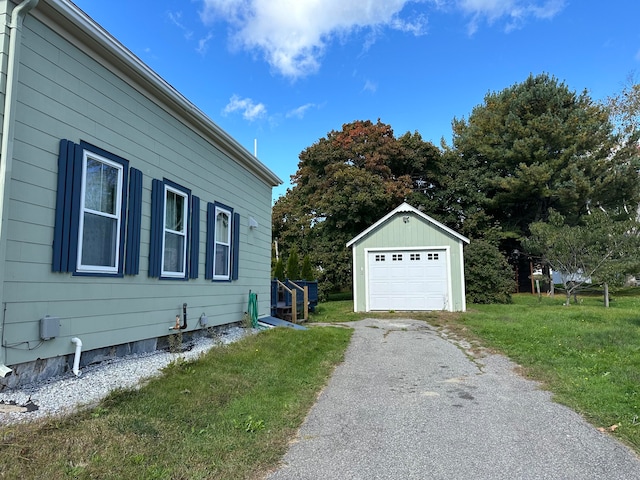 view of home's exterior with an outbuilding, a garage, and a lawn