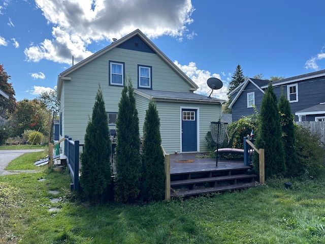 back of house featuring a yard and a deck