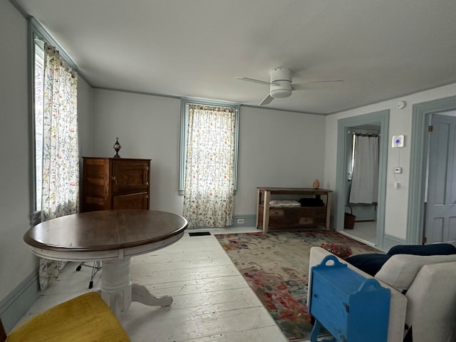 living room with ceiling fan and light hardwood / wood-style flooring