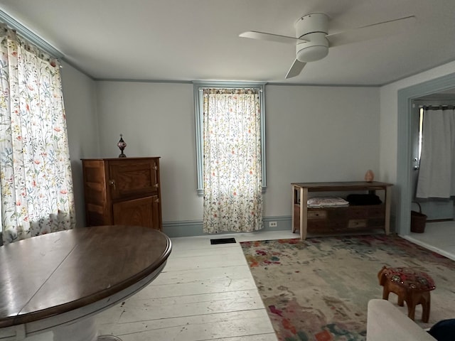 dining space with hardwood / wood-style flooring and ceiling fan