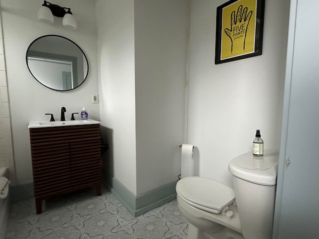 bathroom featuring tile patterned floors, vanity, and toilet