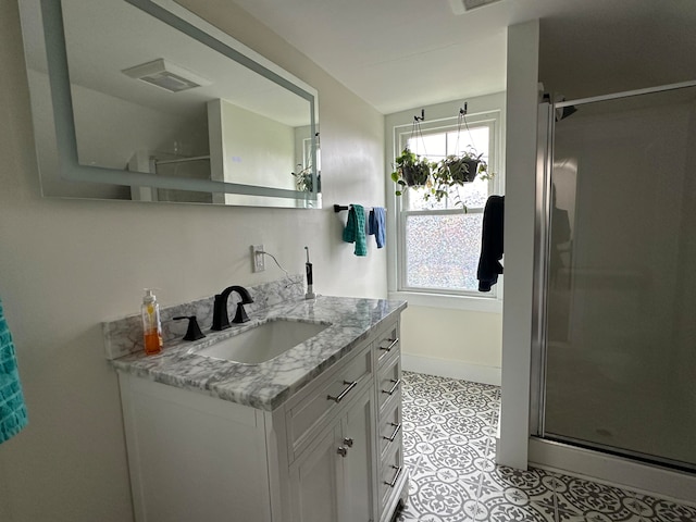 bathroom featuring tile patterned flooring, vanity, and an enclosed shower