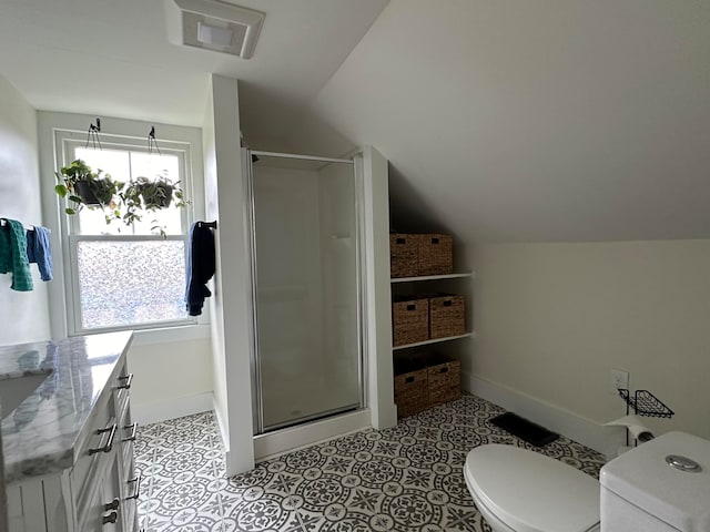 bathroom featuring an enclosed shower, lofted ceiling, toilet, and vanity