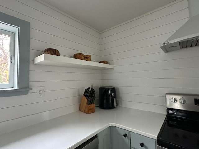 mudroom featuring wooden walls