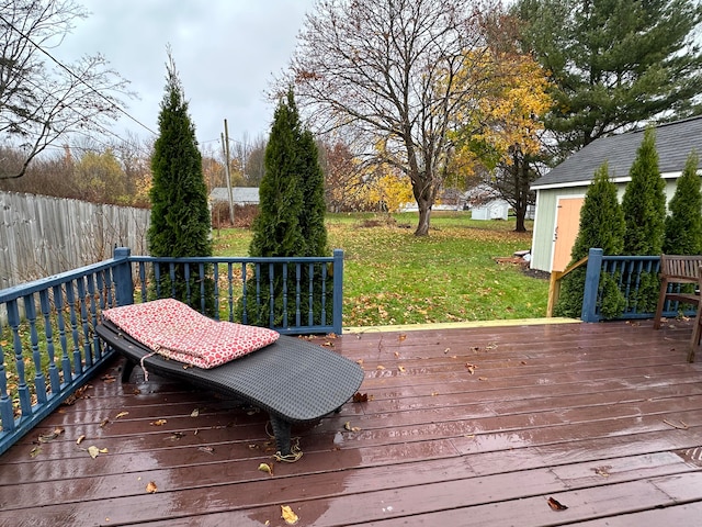 wooden deck featuring a lawn