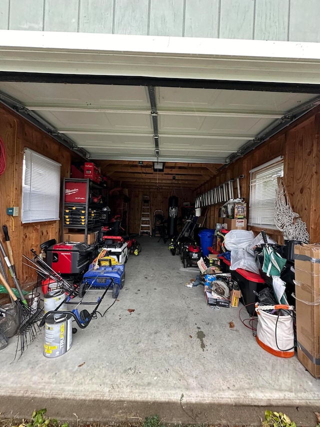 garage featuring wood walls and a garage door opener