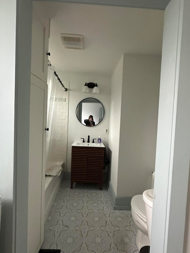 full bathroom with tile patterned floors, vanity, toilet, and shower / bath combination with curtain