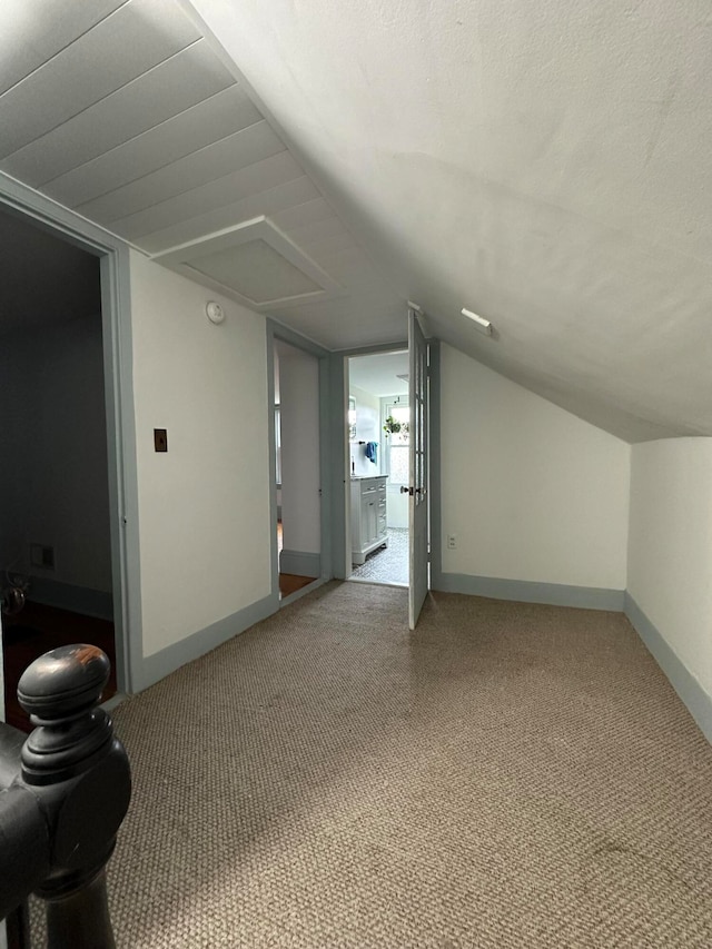 bonus room featuring carpet, lofted ceiling, and a textured ceiling