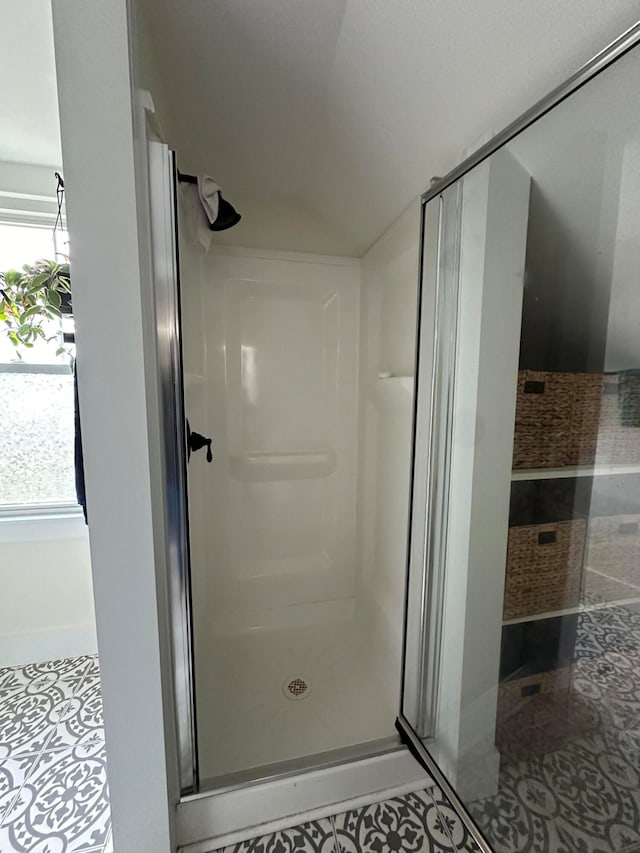 bathroom featuring tile patterned flooring and an enclosed shower