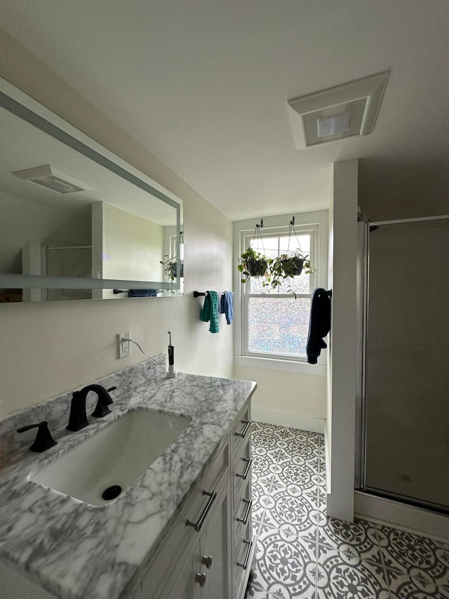 bathroom featuring an enclosed shower, vanity, and tile patterned floors