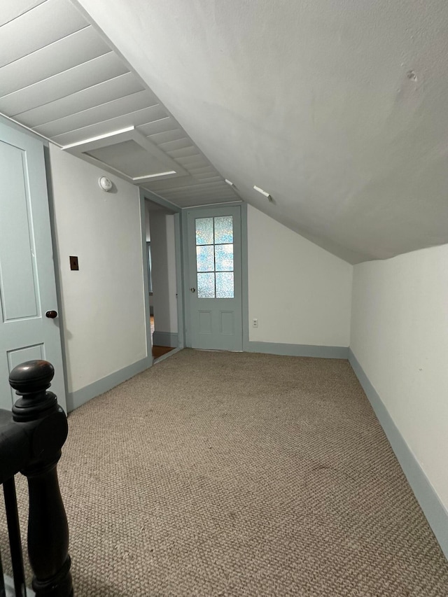 bonus room with carpet floors and lofted ceiling