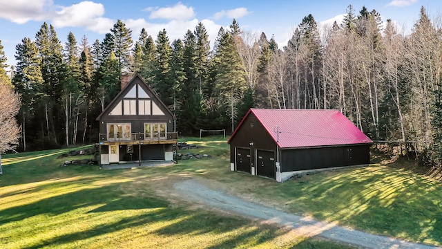 exterior space with a garage, a front lawn, and an outdoor structure