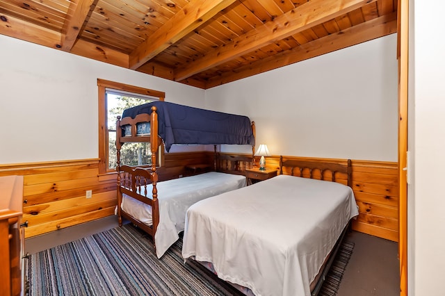 bedroom with beamed ceiling, wooden walls, and wooden ceiling