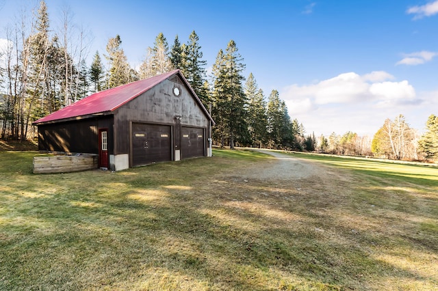 view of yard featuring an outbuilding and a garage