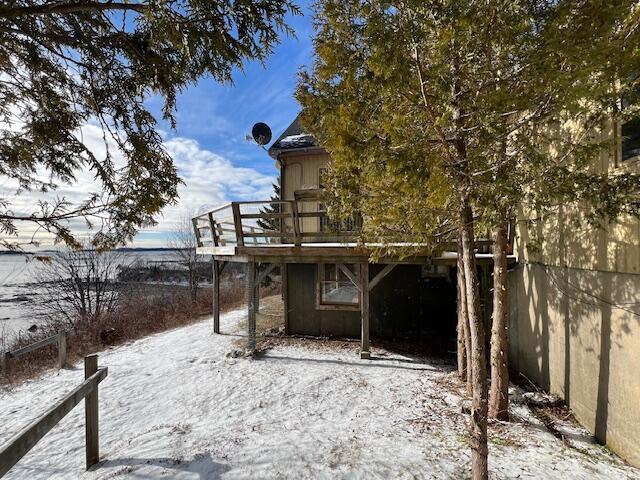 snowy yard featuring a deck