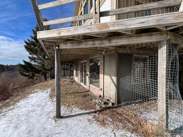 view of snow covered exterior with an outdoor structure