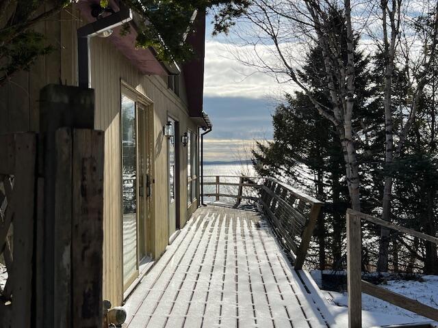 view of snow covered back of property