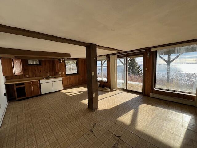 unfurnished sunroom featuring a healthy amount of sunlight and sink