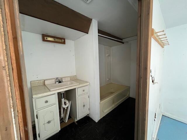 bathroom featuring a tub to relax in and vanity