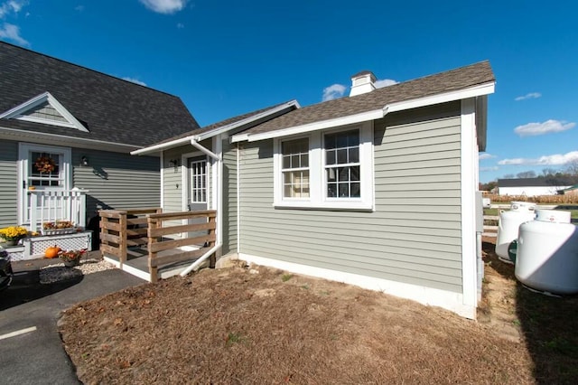 rear view of property featuring a deck