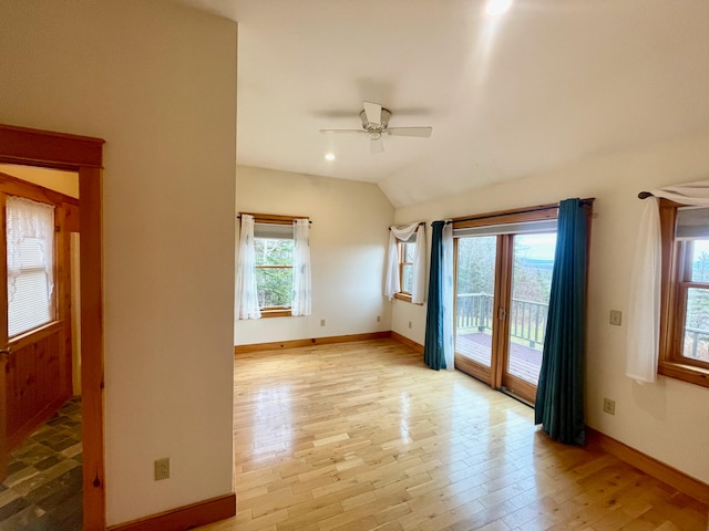 unfurnished room featuring french doors, ceiling fan, light hardwood / wood-style flooring, and lofted ceiling