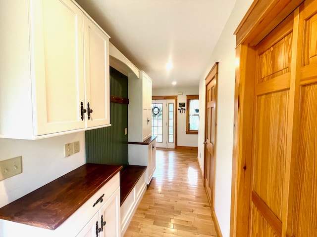 corridor with light wood-type flooring