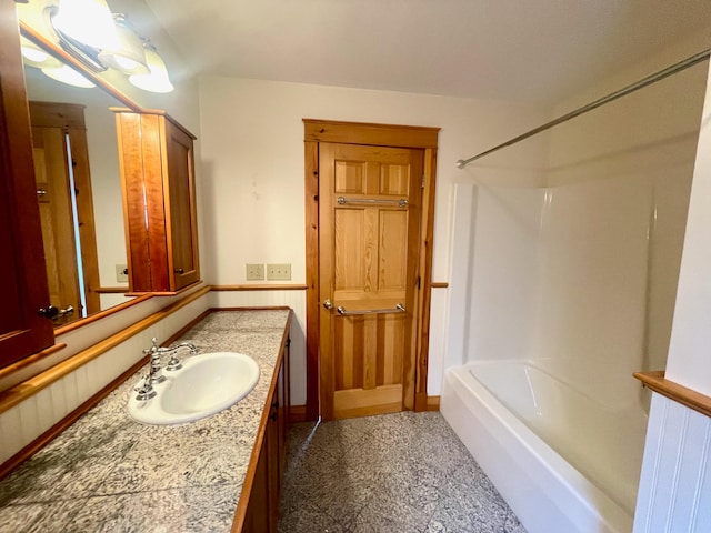 bathroom featuring shower / tub combination, wood walls, and vanity