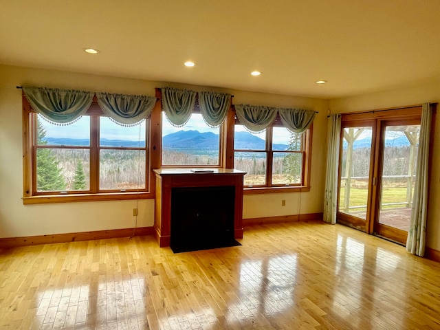 unfurnished sunroom with a mountain view