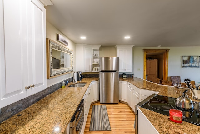 kitchen featuring white cabinetry, sink, electric range, light stone countertops, and stainless steel fridge