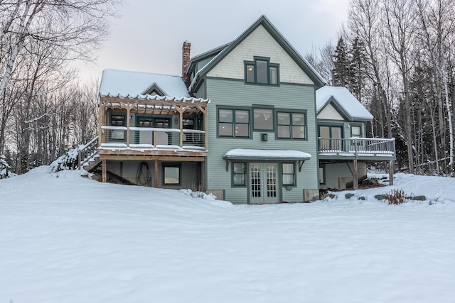 view of snow covered rear of property