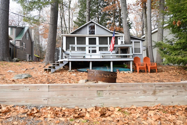 55 Lakeshore Dr, Casco, ME 04015 - view of front of house featuring stairway, a wooden deck, and a sunroom