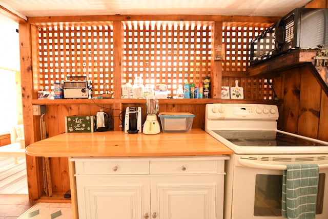 kitchen with white range with electric stovetop and white cabinetry