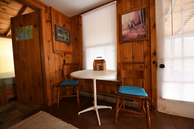 dining area with wood walls, vaulted ceiling, and dark hardwood / wood-style flooring