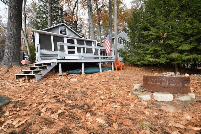 55 Lakeshore Dr, Casco, ME 04015 - rear view of property featuring a sunroom, stairs, and view of wooded area