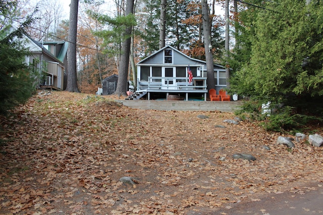 exterior space featuring a deck and a storage shed