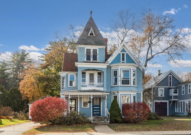 victorian home with a garage and a porch