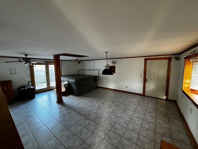 unfurnished living room with light tile patterned floors, ceiling fan, and crown molding