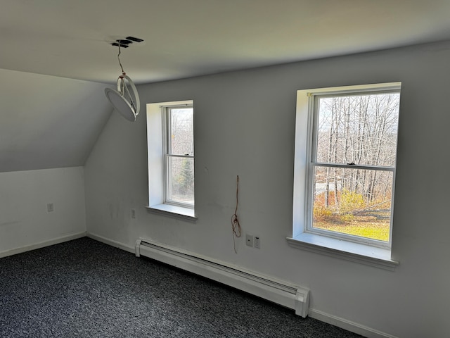 bonus room with a baseboard radiator, dark carpet, a wealth of natural light, and lofted ceiling