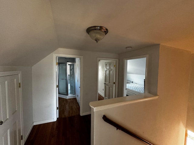 corridor featuring dark hardwood / wood-style flooring and lofted ceiling