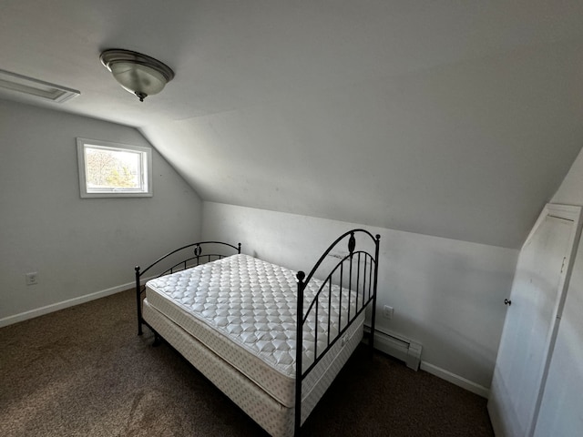 bedroom featuring dark colored carpet, lofted ceiling, and a baseboard heating unit