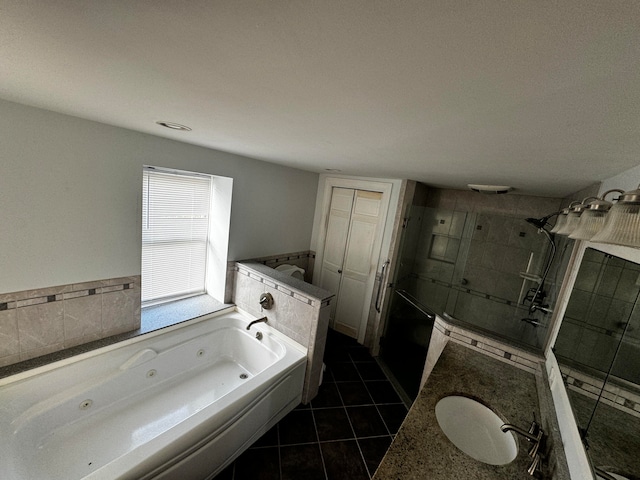 bathroom featuring tile patterned flooring, vanity, and plus walk in shower