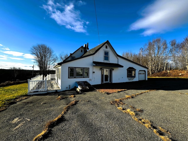 view of front of property featuring a garage and a deck