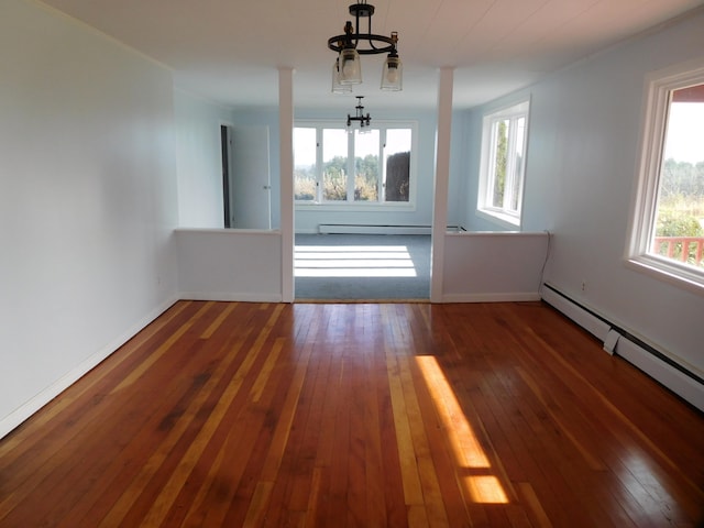 interior space with baseboard heating, dark wood-type flooring, and a notable chandelier