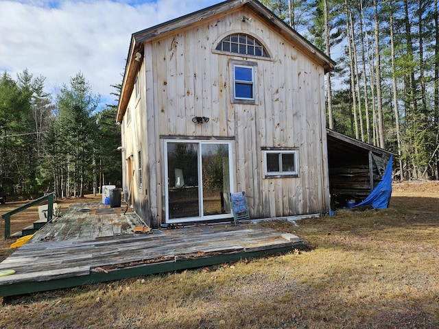 back of house with a deck