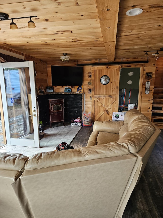 living room with wooden walls, hardwood / wood-style floors, and wooden ceiling