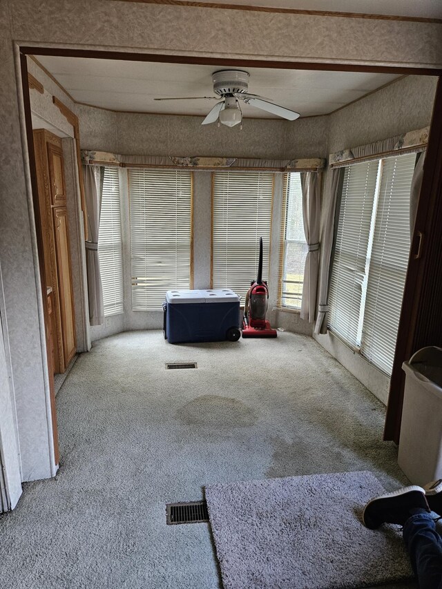 bedroom with light carpet and ceiling fan