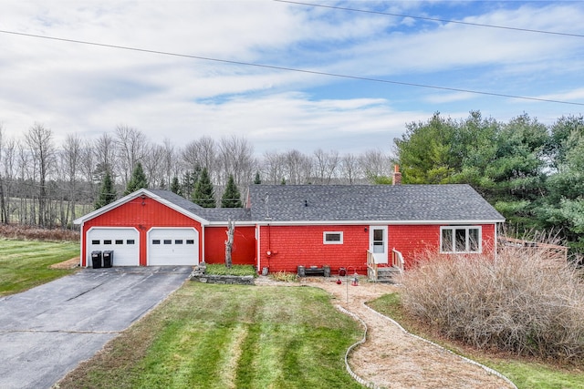 ranch-style home featuring a garage and a front yard