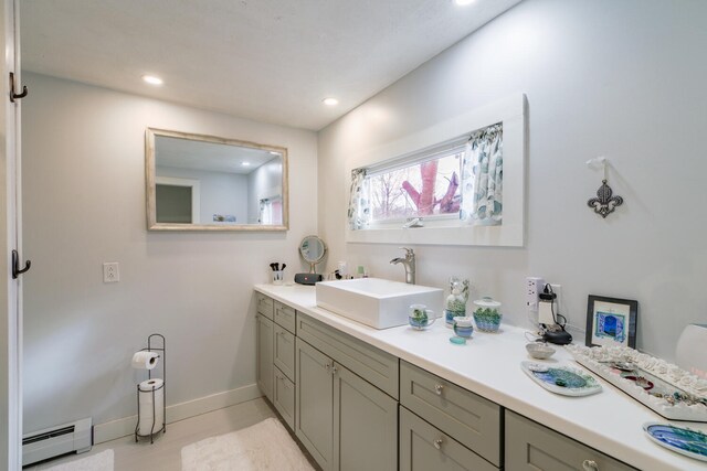 bathroom with tile patterned flooring, vanity, and baseboard heating